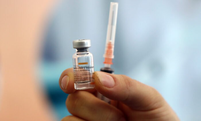 A health worker shows a dose of CoronaVac vaccine during a COVID-19 vaccination campaign in Ankara, Turkey, on Jan. 27, 2021. (Adem Altan/AFP via Getty Images)