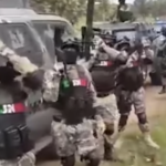 WATCH: Armed masked gunmen in front of armored vehicles chant name of wanted Jalisco Cartel boss