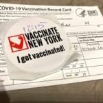 A proof of vaccination record card and sticker at Grand Central Station in New York City. (STRF/STAR MAX/IPx)