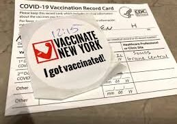 A proof of vaccination record card and sticker at Grand Central Station in New York City. (STRF/STAR MAX/IPx)